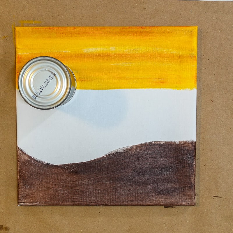 use a tin can to create a circle for the sun on the sunset beach painting