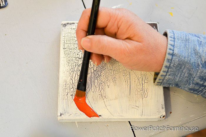 Painting an orange pumpkin with acrylic paint