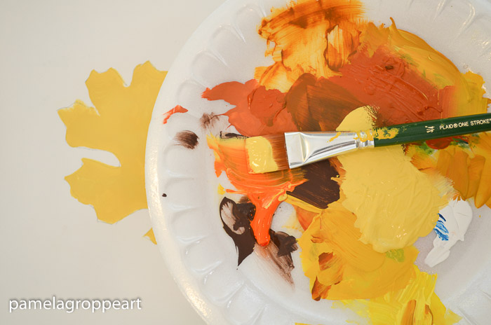 yellow and orange paint on paint brush