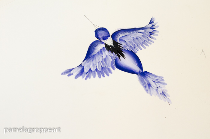 Paint white feathers on neck of flying blue bird