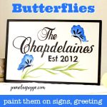 Blue butterflies hand painted on a sign, with text overlay, pamelagroppe.com