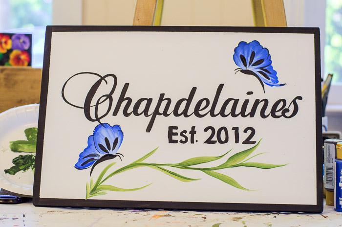 Blue butterflies painted on a sign