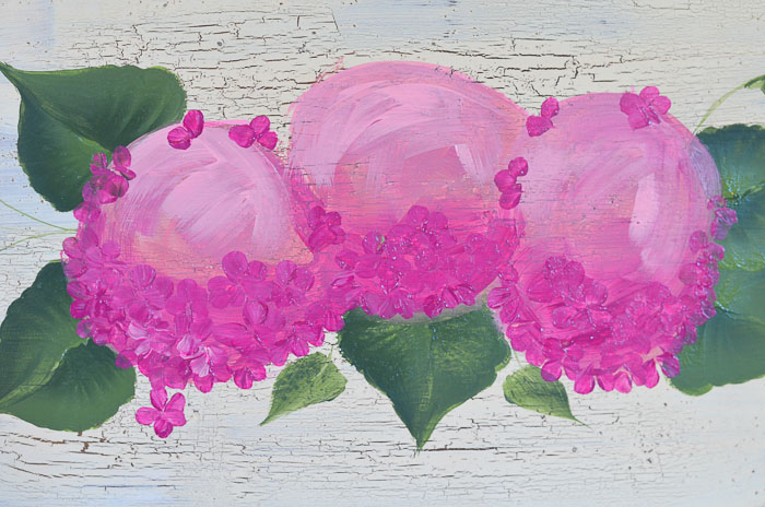 Dark petals being painting on pink hydrangeas