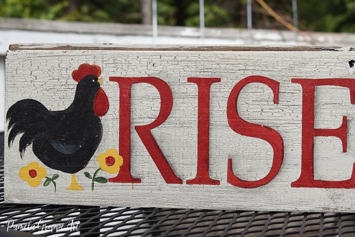 Portion of diy hand painted sign with crackle finish, rooster motif