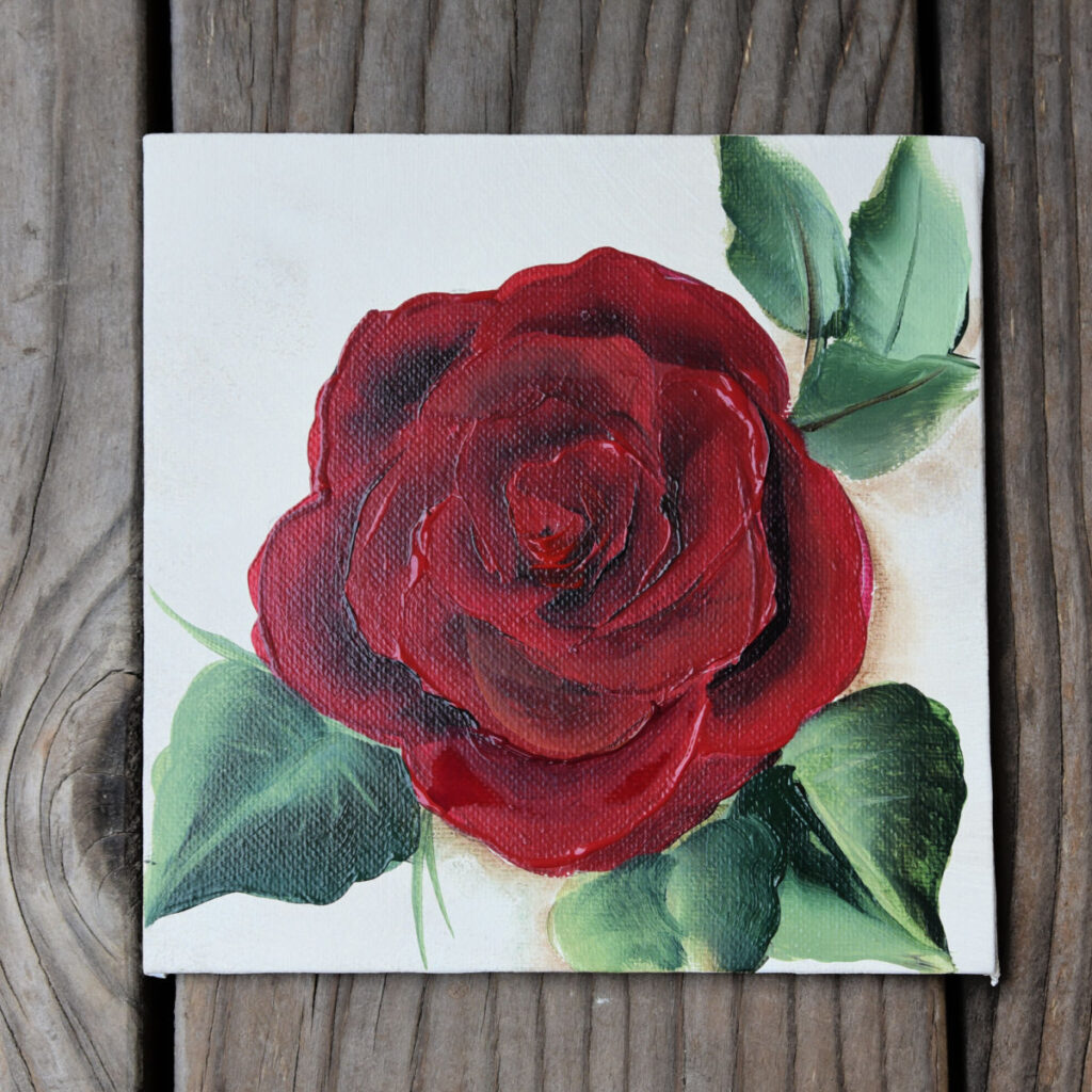 red rose painted in acrylics on wood background