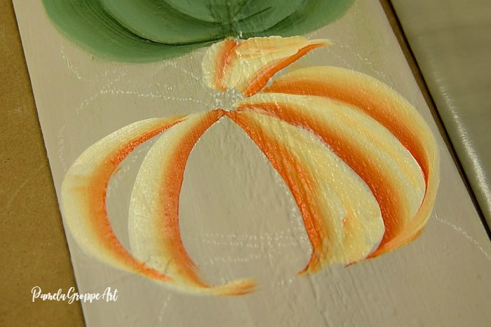 Painting the back ribs of a tiger pumpkin, Pamela Groppe Art