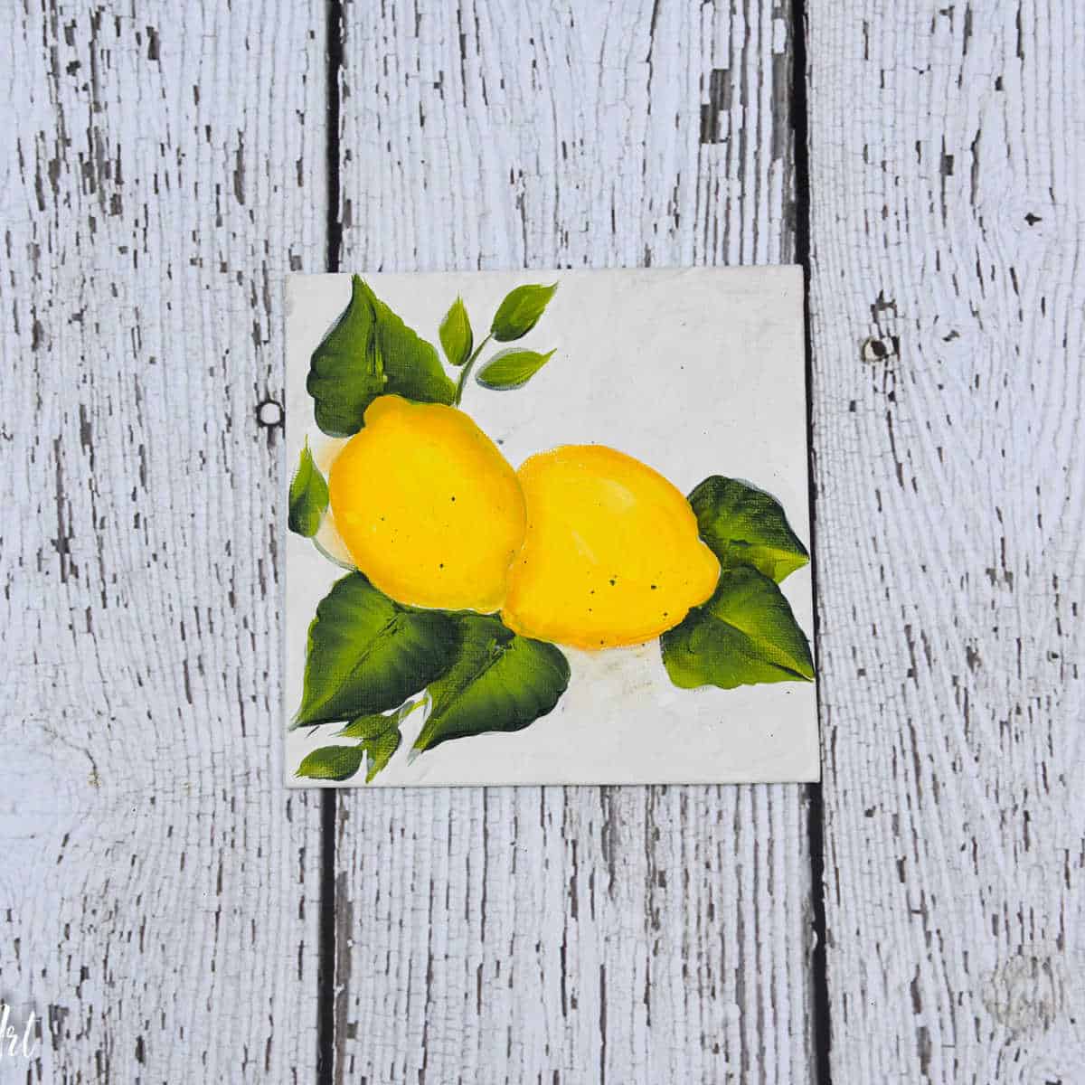 lemons painted on canvas board.