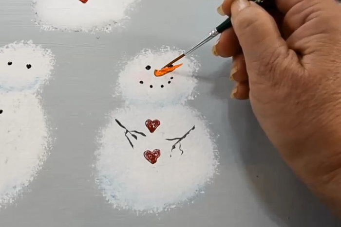 painting a carrot now on snowman face