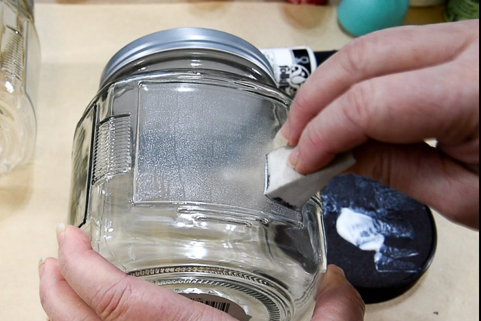 applying a frost finish paint to a square jar with a make up sponge