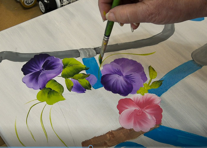 Adding leaves and greenery to bicycle painting basket