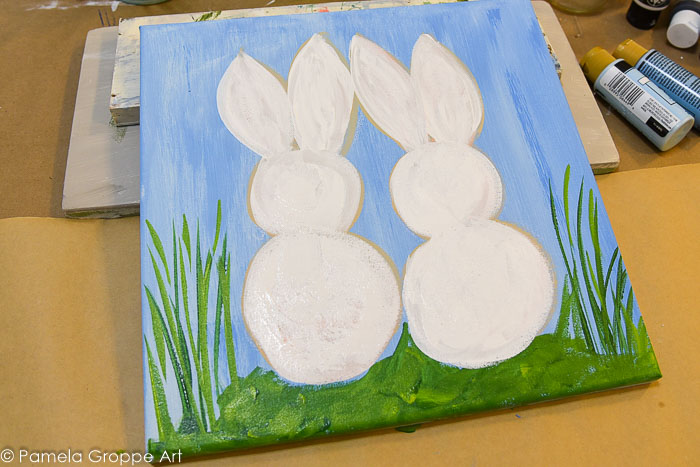 white bunnies painted on a canvas