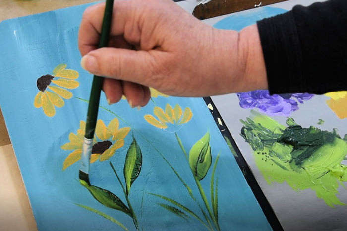 Paint flower stems and paint leaves with a sliding stroke