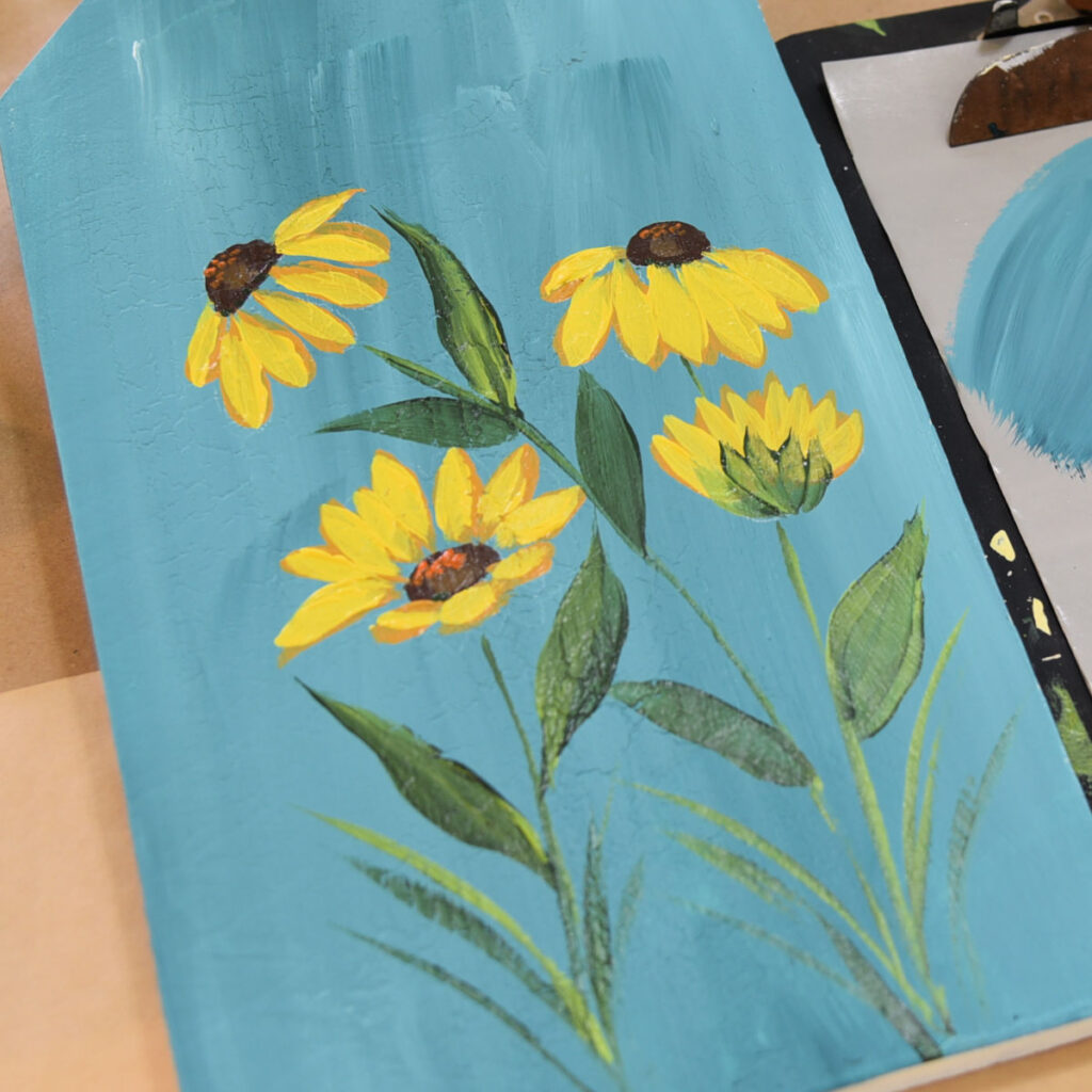 black eyed susans painted in acrylics on blue background,