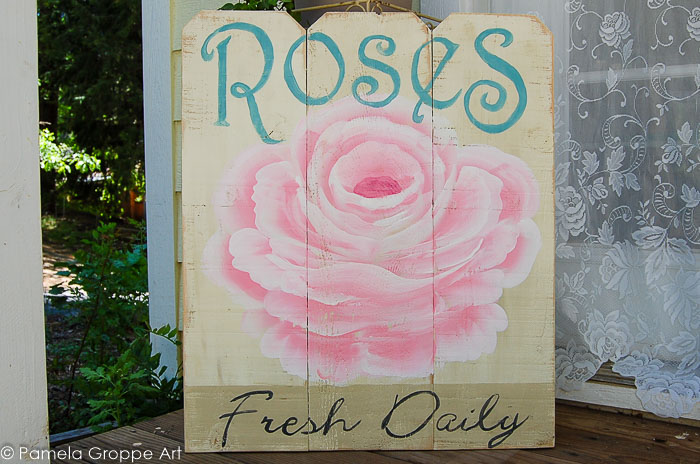 Rose advertising diy sign on cedar fence boards