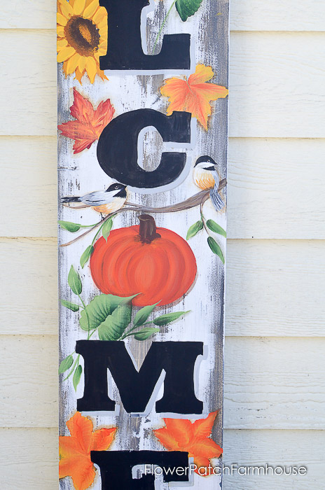 Orange pumpkin and chickadee painted on wood board for Fall Welcome sign