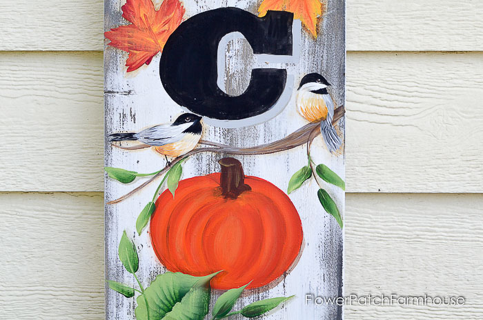 pumpkin, chickadee and leaves painted on wood sign