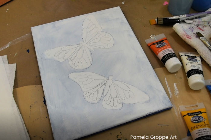 white canvas with tracing of Monarch butterflies to paint