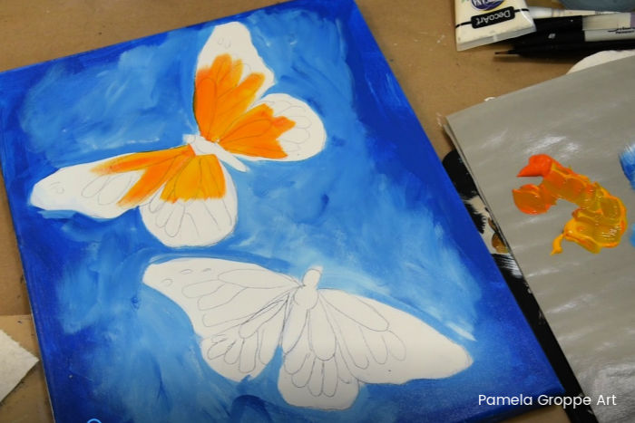 Paint a butterfly, add yellow and orange to wings