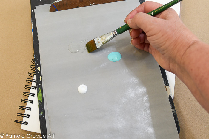 Dip paint brush into floating medium