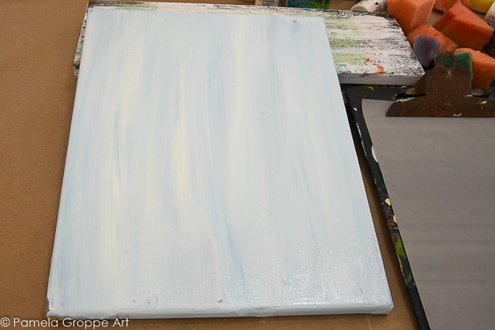 streaky background of warm white and blue on canvas