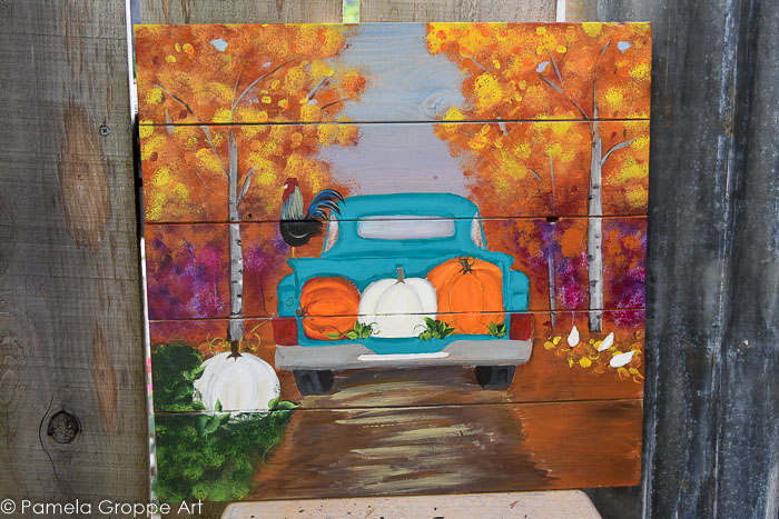 Fall truck with pumpkins painted on pallet wood canvas.