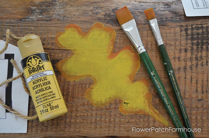 painted oak leaf with paint bottle and brushes