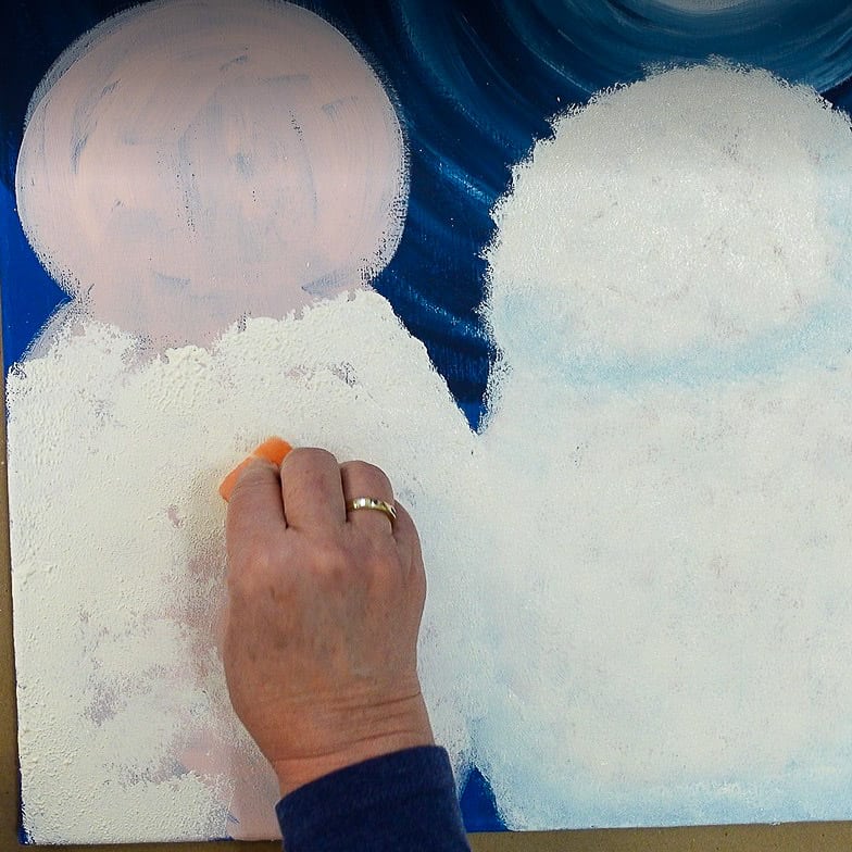 sponge pounce white paint to create snow texture on snowman painting