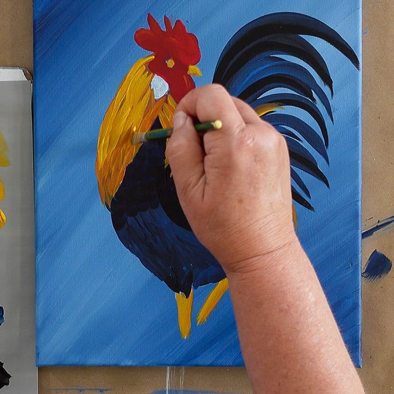 brighten neck feathers of rooster with yellow paint, pamela groppe art