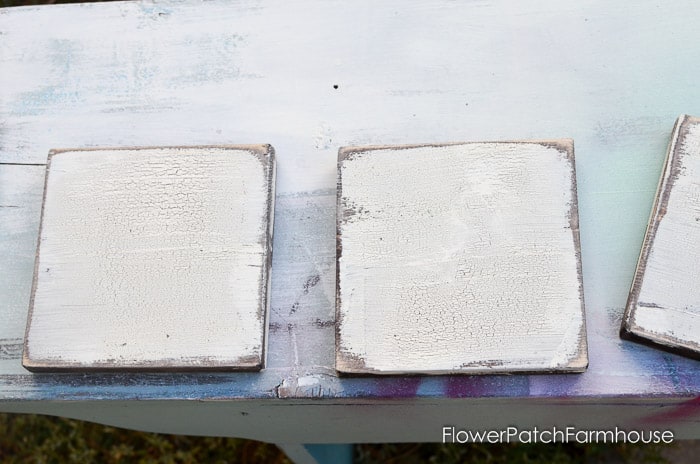 white paint with crackle finish on wood scrabble tiles before painting letters