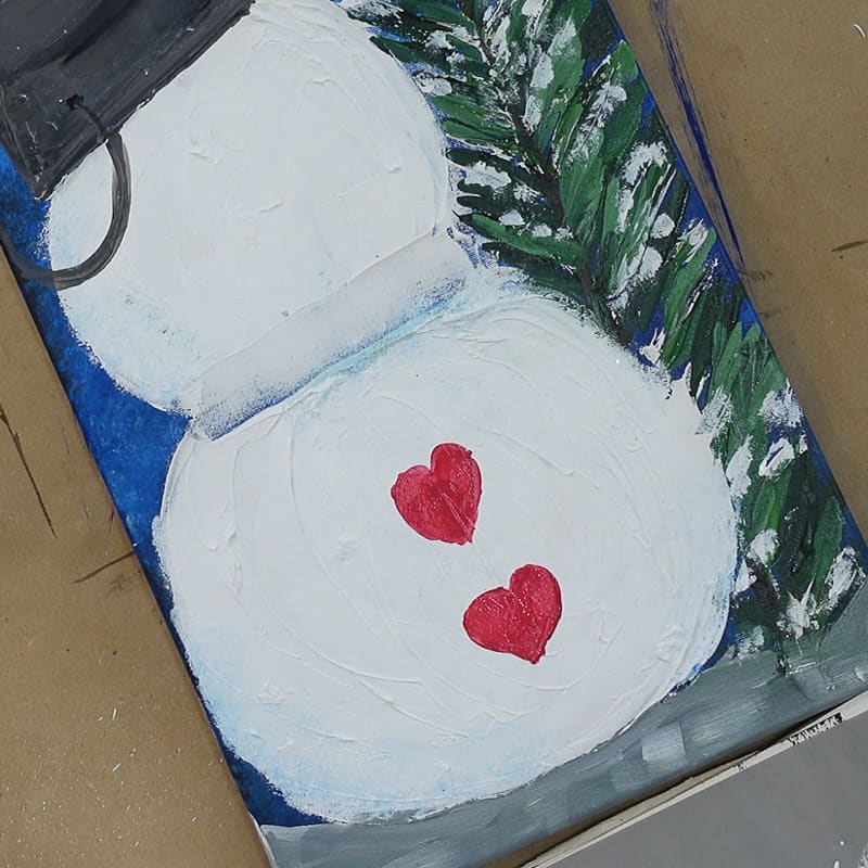 Paint red heart buttons on snowman