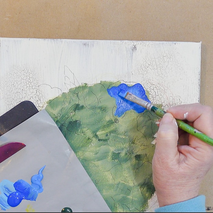 painting a morning glory onto the topiary