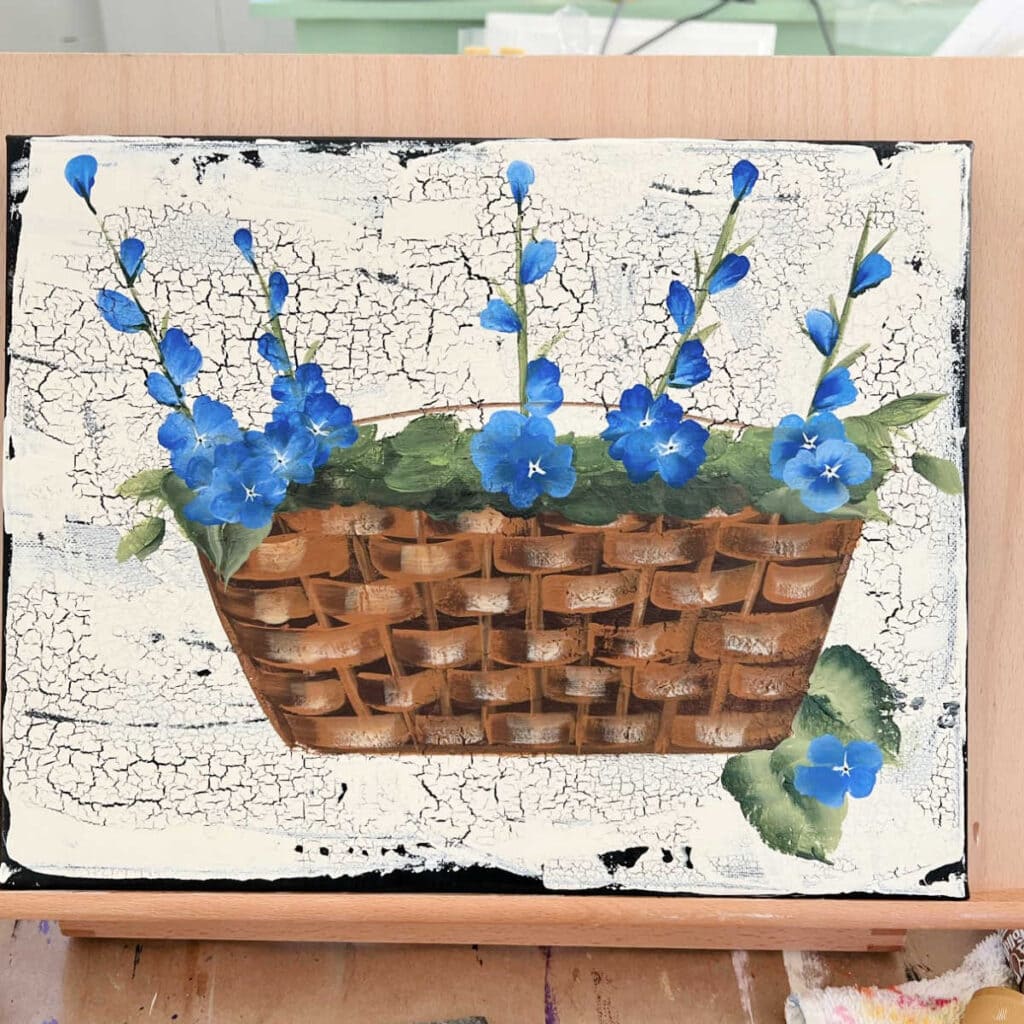 blue flowers in a basket painted in acrylics