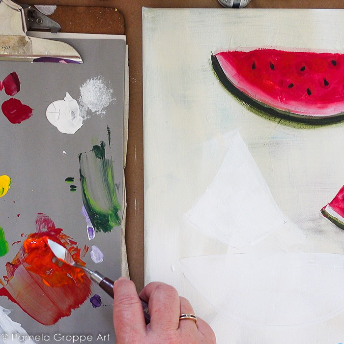 Mixing orange and red acrylic paint to base watermelon painting