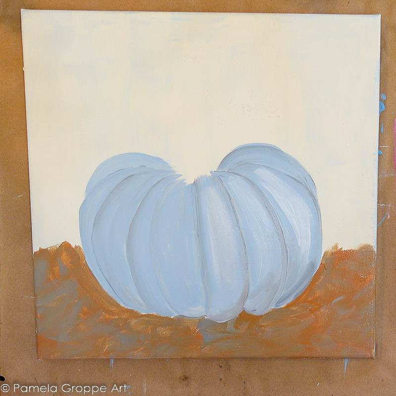 adding white highlights and grey shadows to blue painted pumpkin