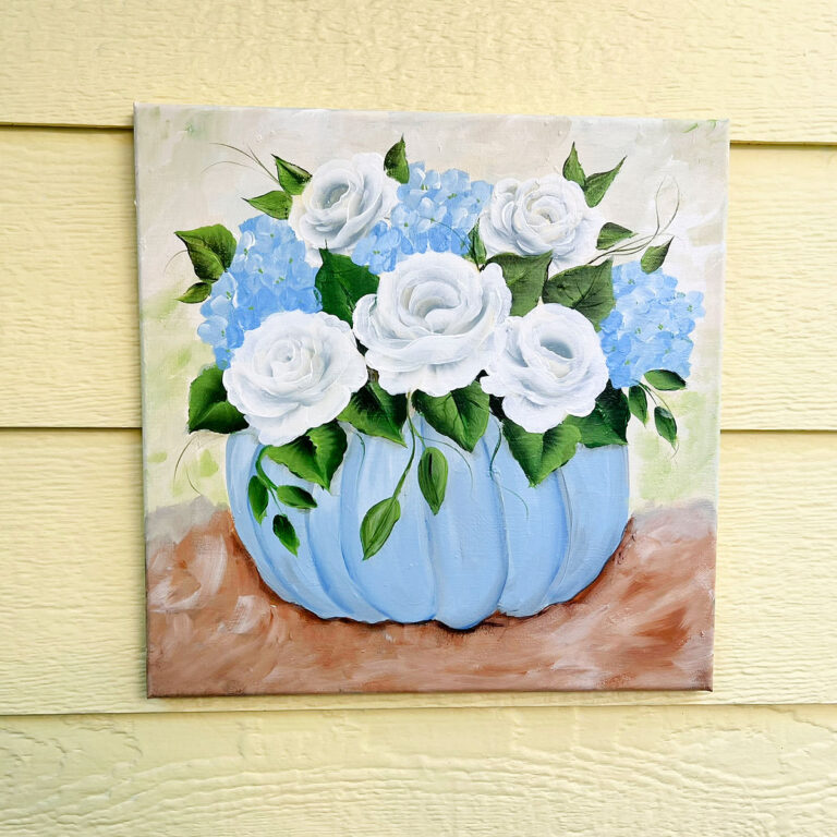 acrylic painting of blue pumpkin with white roses and hydrangeas on square canvas