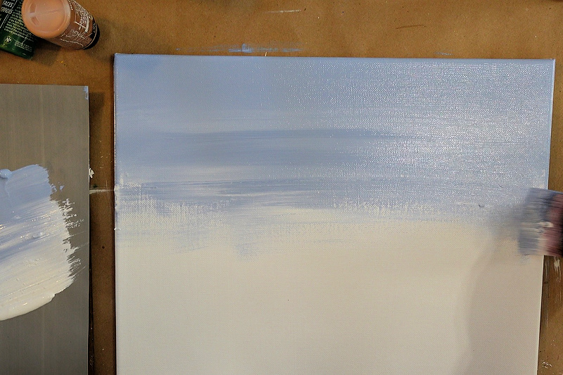 painting a winter sky on a white canvas