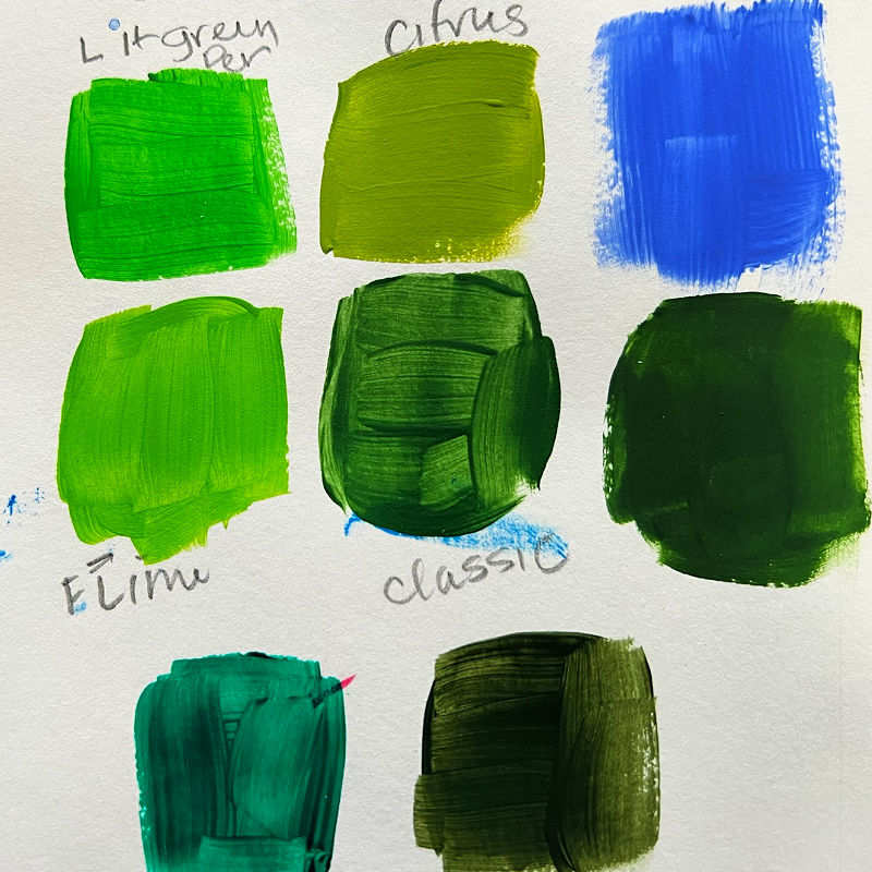 Green acrylic paint swatches on a white background