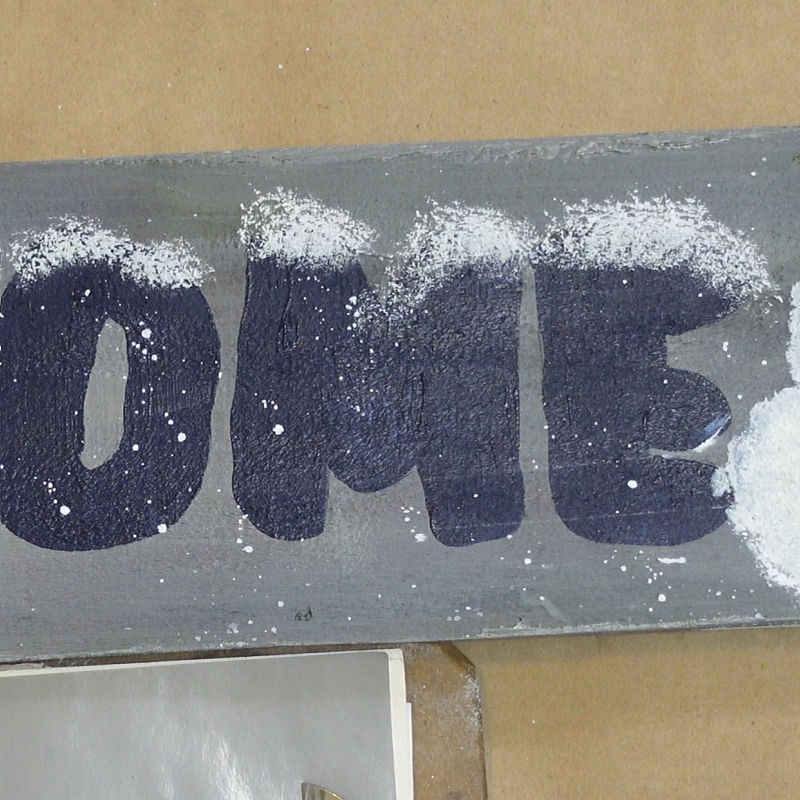 tap white onto top of letters of the word welcome