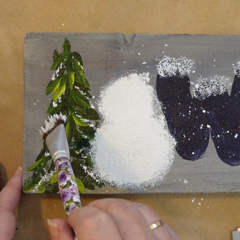 tap white onto the evergreen trees to mimic snow