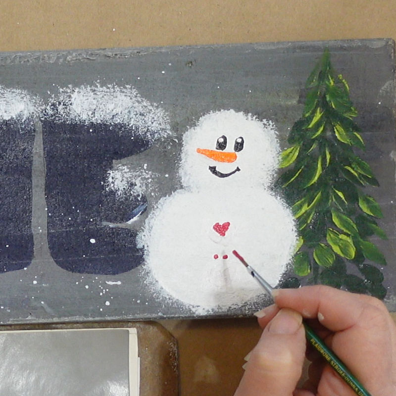 with red and the liner brush create a heart for the buttons on his chest.
