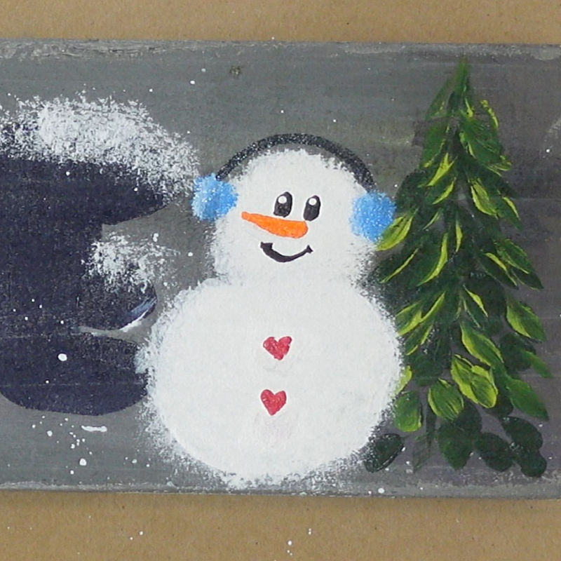 blue ear muffs have been added to the snowmans head