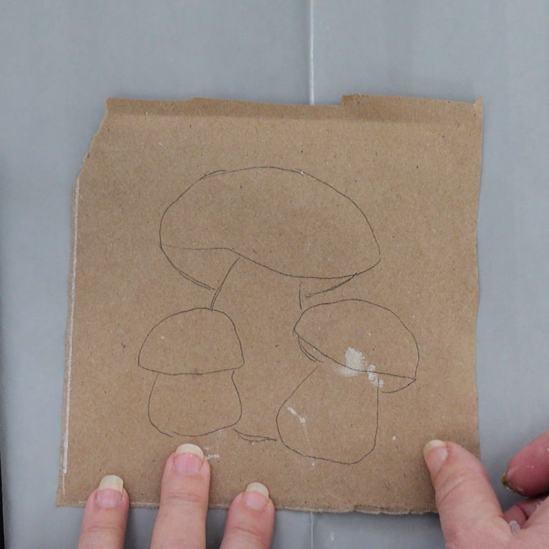 mushroom design traced on to brown paper to be painted